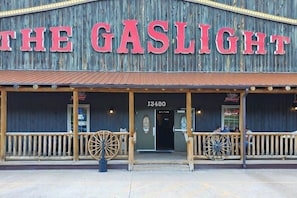 A building with a rustic exterior and a prominent sign reading 'THE GASLIGHT'. - Stratobowl Escape - Dual-Unit Home Near Black Hills Fun (Rapid City)