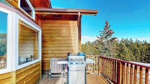 A wooden deck with a barbecue grill and a grill cabinet. - Hilltop Getaway - Hilltop Home • Hot Tub & Billiards (Lead)