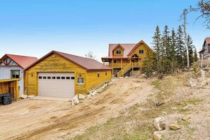 A wooden cabin with a garage and a staircase leading to a second level. - Liberty Lodge at Terry Peak - Ski-In/Ski-Out Lodge • Hot Tub (Lead)