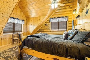 A log cabin bedroom with a bed, a ceiling fan, and a window with blinds. - Liberty Lodge at Terry Peak - Ski-In/Ski-Out Lodge • Hot Tub (Lead)
