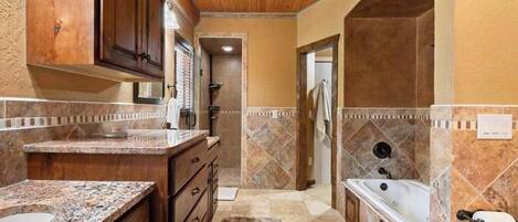 A bathroom with a bathtub, a toilet, and a sink.
