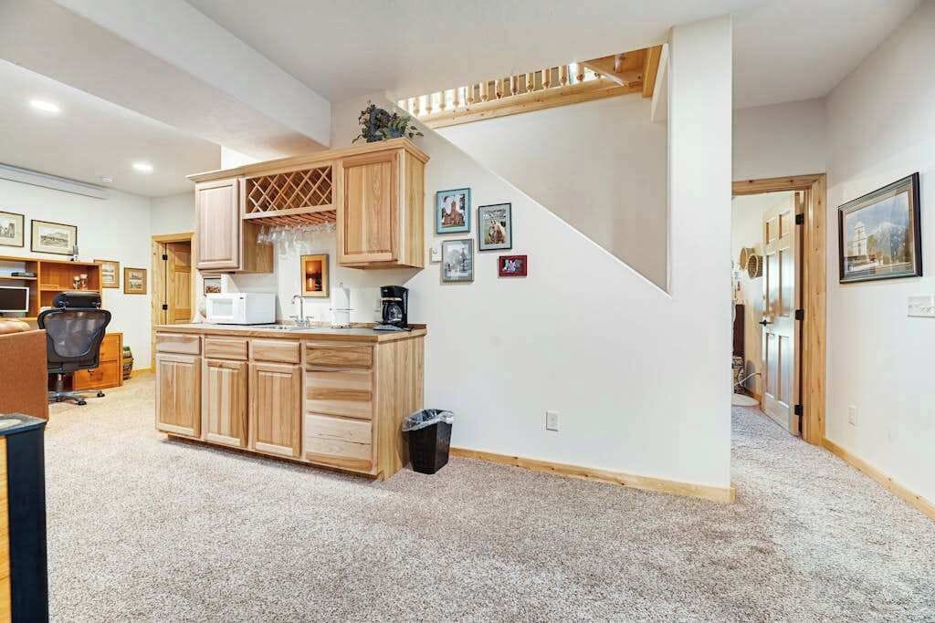 A home interior with a kitchen area, a staircase, and a living room.