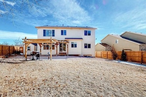 A two-story house with a covered patio area. - Windy Hill Retreat - Dog-Friendly Home • Huge Fenced Yard (Colorado Springs)