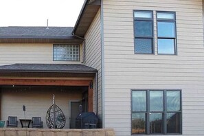 A two-story house with a covered patio area.