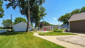 A residential area with houses, a playground, and a clear sky. - Paddle & Play on Long Lake - Lakefront Retreat (Scotts)