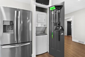 A modern kitchen with a stainless steel refrigerator, a built-in oven, and a microwave. - Paddle & Play on Long Lake - Lakefront Retreat (Scotts)