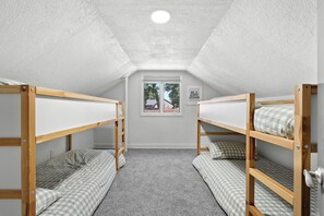 A dormitory room with bunk beds, a window, and a motivational poster on the wall. - Paddle & Play on Long Lake - Lakefront Retreat (Scotts)