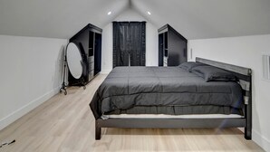 A bedroom with a bed, a vanity with a mirror, and a wardrobe. - Luxury Vineyard Barn Retreat with Private Trails Near Nashville, Georgia (Nashville)