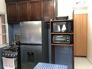 A compact kitchen with a stainless steel refrigerator, a microwave, and a toaster oven. - Close to the ocean—the perfect spot to explore Puerto Plata on foot (Puerto Plata)