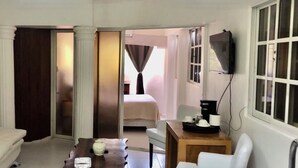 A hotel room with a sofa, a small table, a TV, and a bed. - Close to the ocean—the perfect spot to explore Puerto Plata on foot (Puerto Plata)