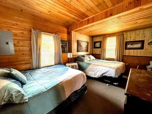 A cabin-style room with two beds, wooden walls, and a wooden ceiling. - Family and Dog Friendly Lakefront Cabin in Maine near Tidal Falls and Kisma Preserve (Sullivan)