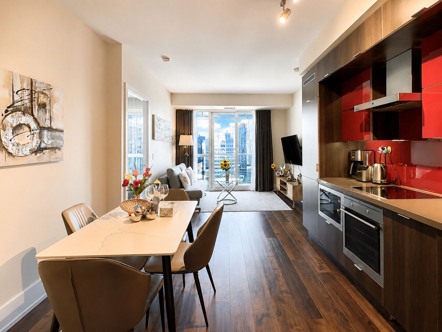 A modern apartment with a dining area, kitchen, and a balcony with a city view.
