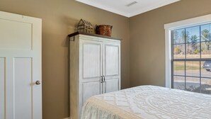 A bedroom with a bed, a wardrobe, and a window with a view. - The Fairview Hideaway (Fairview)
