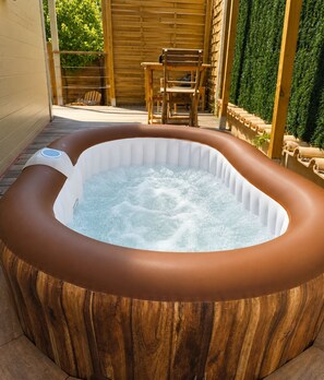 A hot tub in a wooden tub with a wooden deck and chairs. - Ailéa – Tiny House with a Private Hot Tub in Provence (Beaumes-de-Venise)