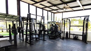 A gym with various exercise equipment, large windows, and a covered roof. - Spacious 5-bedroom MANSION in tranquil Guarne perfect for families & events (Guarne)