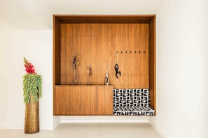 A wooden cabinet with a mirror, a vase, and a patterned rug. - Villa Aquarama with Pool (Okrug Gornji)