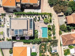 An aerial view of a property with a swimming pool, a covered patio, and a landscaped garden. - Villa Aquarama with Pool (Okrug Gornji)
