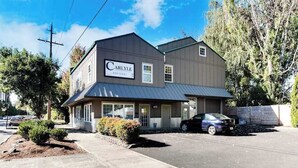 A two-story building with a sign that reads 'Carlyle.' - High-End Studio Oregon Wine Country (McMinnville)