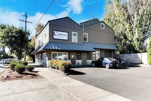 A two-story building with a sign that reads 'Carlyle.' - High-End Studio Oregon Wine Country (McMinnville)