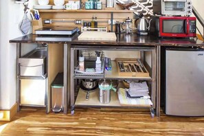 A compact kitchen with a microwave, toaster, and stainless steel appliances. - Micro-Loft Surrounded by Gardens in Hip Location (Portland)