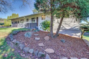 A single-story house with a garage, surrounded by a landscaped garden with rocks and a tree. - Wine Country 3BR Mountainview Oregon Wine Country (Dundee)