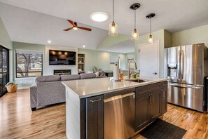 A modern kitchen with a large island, stainless steel appliances, and pendant lighting. - Renovated 3BR Mountainview - Pool - Hot Tub (Manson)
