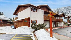 A hotel with a snow-covered parking area and a signpost indicating amenities. - 1 BR condo located in Icicle Village, Leavenworth (Leavenworth)