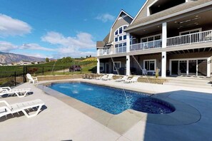 A two-story house with a swimming pool, outdoor seating, and a view of the mountains. - Luxury home - wine country - private pool, hot tub (Manson)