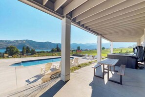 A covered outdoor area with a pool, lounge chairs, a picnic table, and a hot tub. - Luxury home - wine country - private pool, hot tub (Manson)