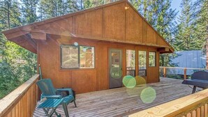 A wooden cabin with a deck, a grill, and a seating area. - Woodland 2BR Mountainview Dog Friendly - Deck (Leavenworth)