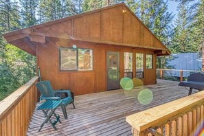 A wooden cabin with a deck, a grill, and a seating area. - Woodland 2BR Mountainview Dog Friendly - Deck (Leavenworth)