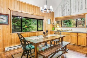 A wooden interior with a dining table, chairs, and a bench. - Alpine 3BR with fenced yard, hot tub, & Ping-Pong (Leavenworth)