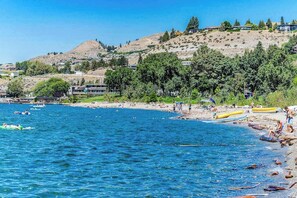A coastal area with a beach, boats, and a hilly landscape in the background. - 2BR Mountainview 2nd-Floor - Balcony - Pool (Chelan)
