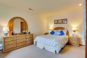 A bedroom with a large bed, a dresser, a mirror, and bedside lamps. - 1BR Lakeview 2nd-Floor - Balcony - Pool (Chelan)