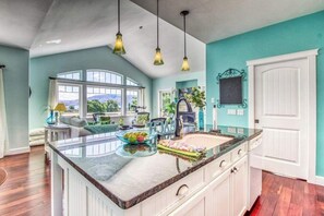 A kitchen with a large island, white cabinetry, and a view of the outdoors. - Huge 2BR Lakeview - Fireplace - Balcony - W&D (Manson)