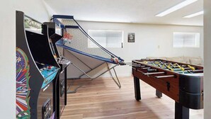 A room with a foosball table and a table tennis table. - 3BR Home & Bunk Room with hot tub, mountain views (East Wenatchee)