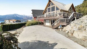 A two-story house with a balcony, a garage, and a view of mountains. - Lovely 3BR Lakeview - Deck - Ping Pong - W&D (Manson)