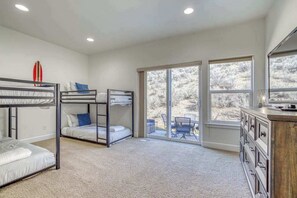 A room with bunk beds, a desk, and a view through large windows. - 3BR Riverview Townhome with shared hot tub & pools (Quincy)