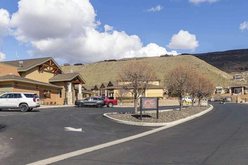 Un hôtel doté d’un parking, d’une enseigne et situé dans un paysage vallonné.
