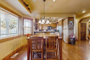 A spacious kitchen with wooden cabinets, a central island, and pendant lighting. - 4BR Lakeview - Fireplace - Deck - W&D (Chelan)