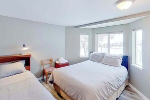 A bedroom with a bed, a chair, a nightstand, and a window. - 2BR Dog-Friendly - Pool (Chelan)