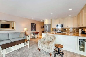 A modern kitchen with white cabinets, stainless steel appliances, and a central island. - 1BR Lakeview 2nd-Floor - Balcony - Pool (Chelan)