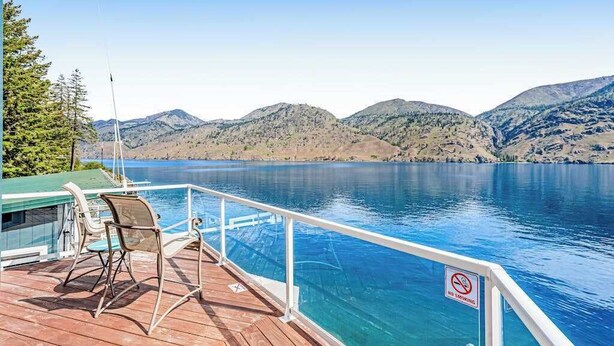 A deck with a pool overlooking a lake with mountains in the background. - 4BR lakefront cottage & bunk house with dock (Chelan)