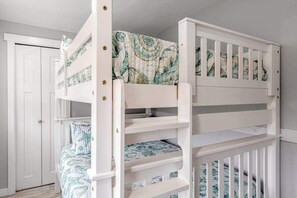A bunk bed with patterned bedding, a white door, and a white railing. - Walk to Downtown 3BR Lakeview - Hot Tub - Deck (Manson)