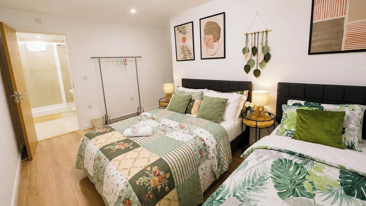 A bedroom with a bed, bedside tables, and a wardrobe.