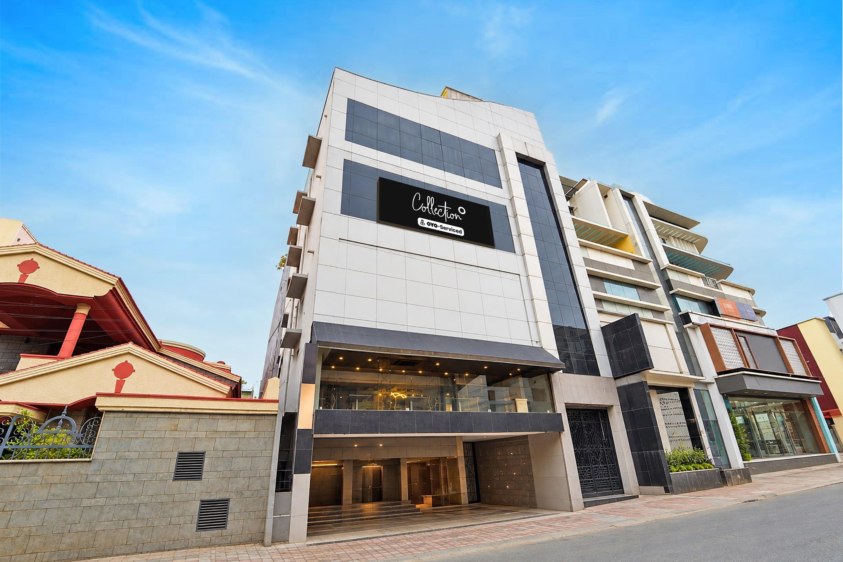 A modern building with a prominent sign reading 'Collection OYO-Serviced.'