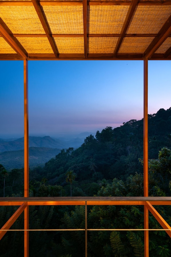 A room with a view of a mountainous landscape.