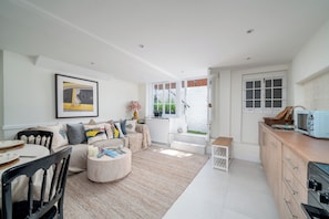 A modern kitchen with a built-in oven and a vintage toaster. - Welcome to your Stylish home in central London. (London)