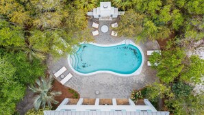 An aerial view of a swimming pool surrounded by lounge chairs and a paved deck. - Professionally Decorated with LSV and Pool (Seacrest Beach)