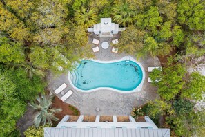 An aerial view of a swimming pool surrounded by lounge chairs and a paved deck. - Professionally Decorated with LSV and Pool (Seacrest Beach)